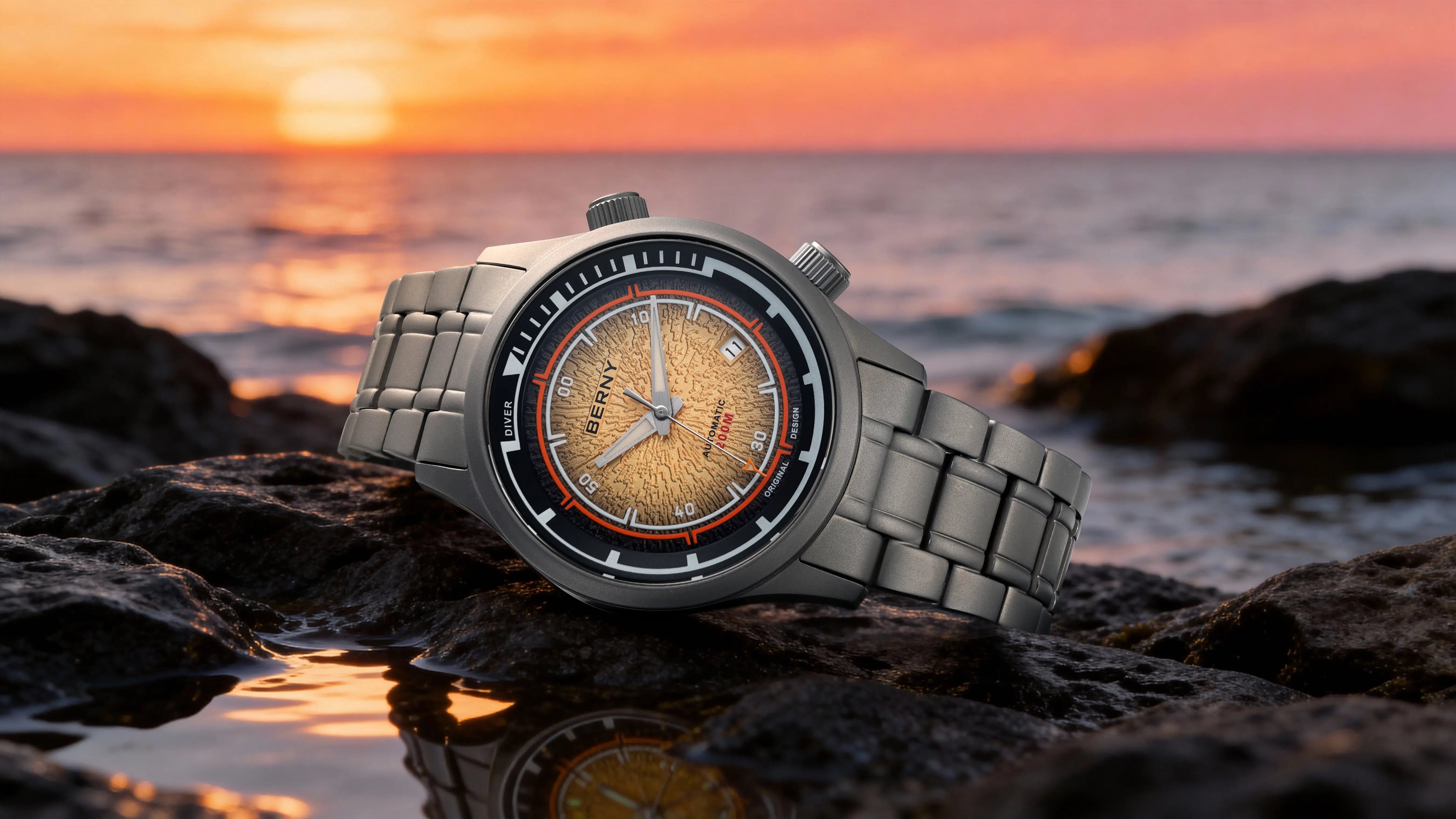 BERNY AMT159M dive watch with a textured orange dial at sunset with ocean backdrop