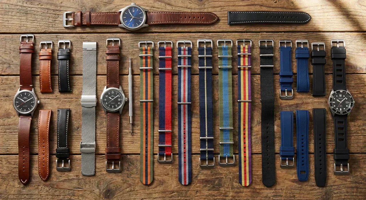 Different types of watch strap materials including leather, metal, NATO and rubber bands displayed on luxury watches