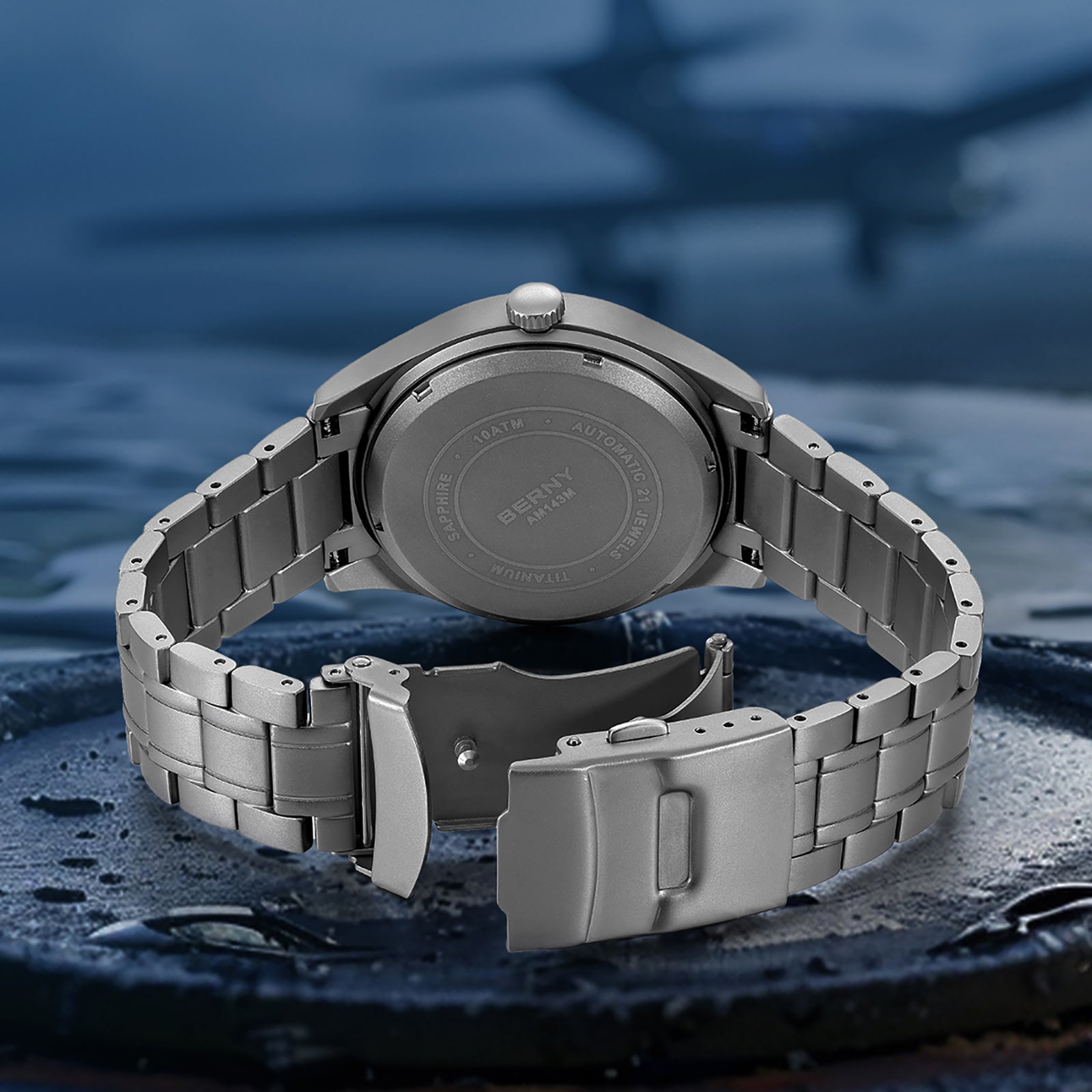BERNY AMT143MS titanium watch shown from the back, featuring a brushed titanium case and a matching band with a folding clasp