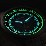 Close-up of glowing Berny watch face with green and blue illumination on a dark background