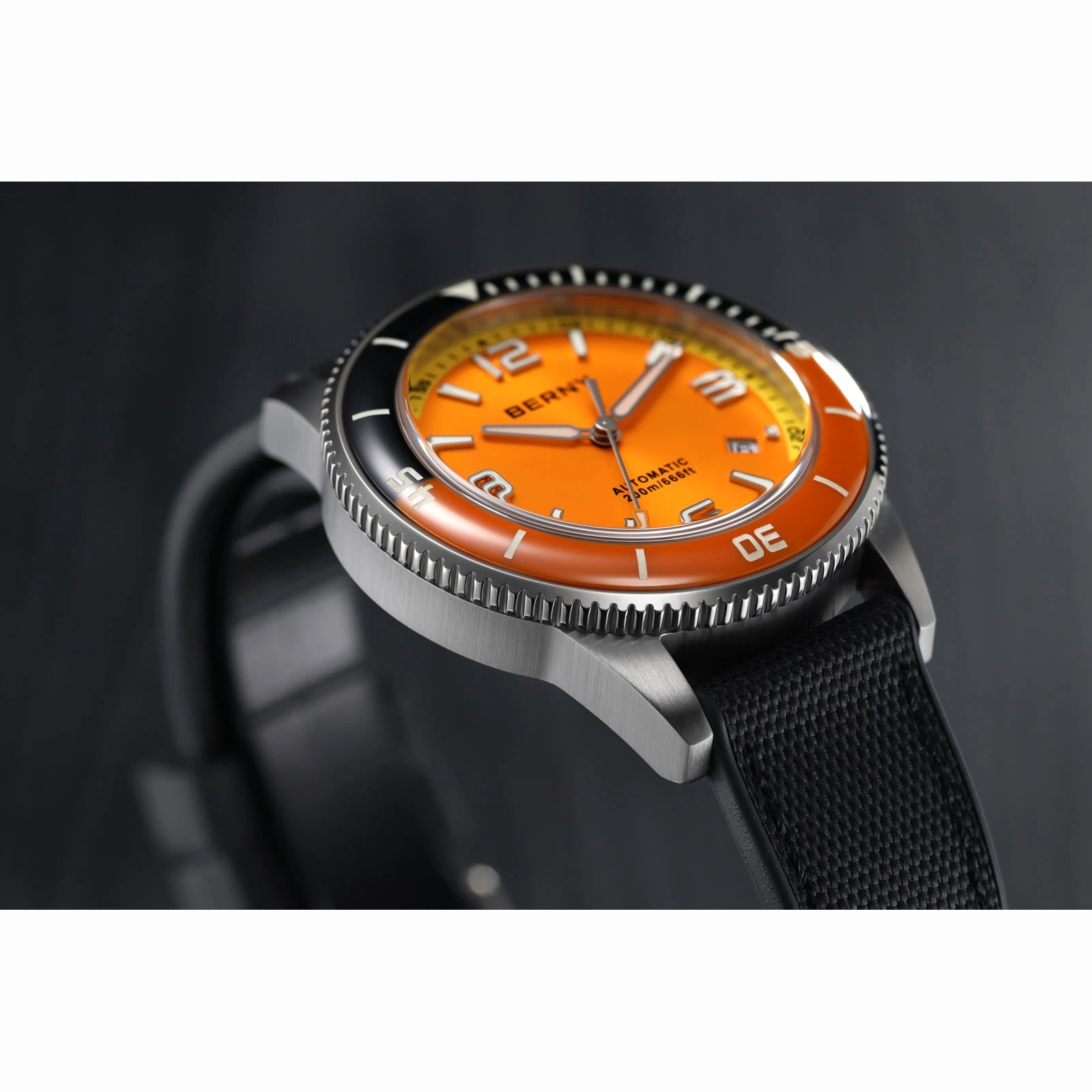 BERNY AM152M orange dial and domed two-tone ceramic bezel, photographed on a real sample